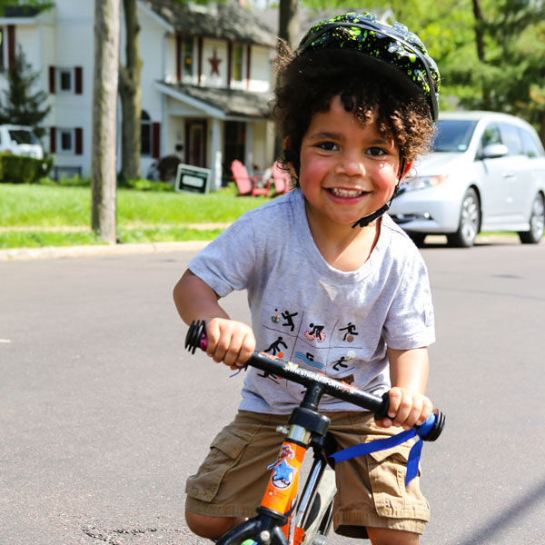 young child on bike with helmet