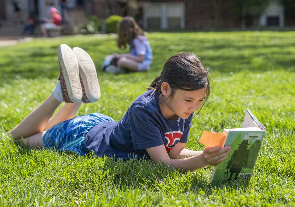 Girl reading in grass